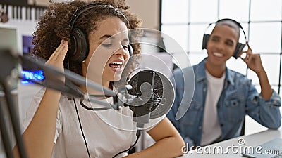 Music artists, enthralling melody of happy musicians singing, dancing and playing in music studio Stock Photo