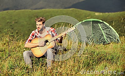 Music brings harmony to the world. western camping and hiking. hipster fashion. happy and free. cowboy man with acoustic Stock Photo
