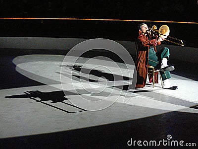 Music clown playing trombone in the circus Editorial Stock Photo