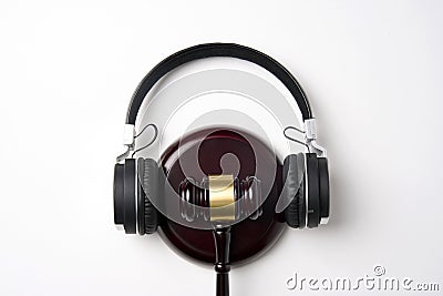 Music copyright law concept. Headphones and judge gavel Stock Photo