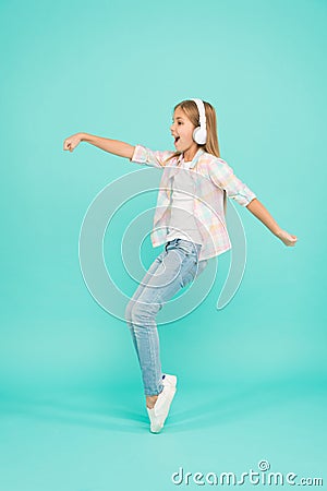 Music drives me dance. Girl child listen music with modern headphones. Kid little girl listen song headphones. Music Stock Photo