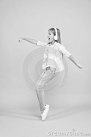 Music drives me dance. Girl child listen music with modern headphones. Kid little girl listen song headphones. Music Stock Photo