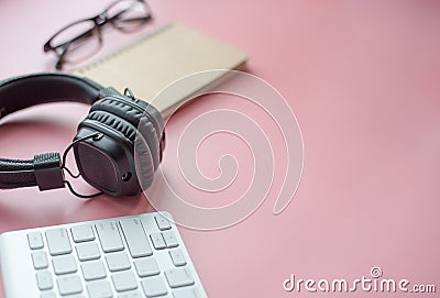 Music headphones beside the keyboard Working life Stock Photo