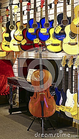 Music instruments store with guitars, piano, cello Editorial Stock Photo