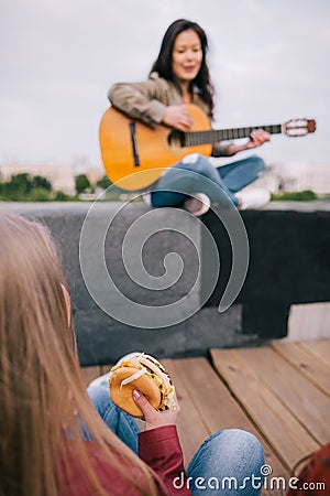 Music junkie with junk food on live show Stock Photo