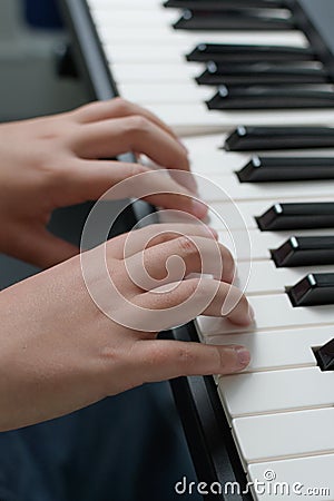 Music lessons. Two hands piano playing exercises. Keyboard close-up Stock Photo