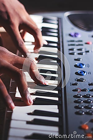 Music magician Playing the Electronic Keyboard in Music Recording studio close up on hands. Playing electronic Piano Stock Photo