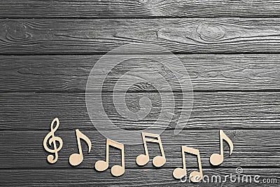 Music notes and treble clef on wooden background, top view Stock Photo