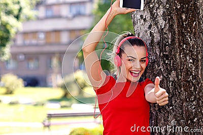 Music passion- Cool woman with headphones listening to music Stock Photo