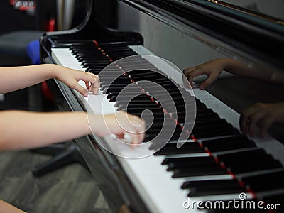 Music performer& x27;s hand playing the piano Stock Photo