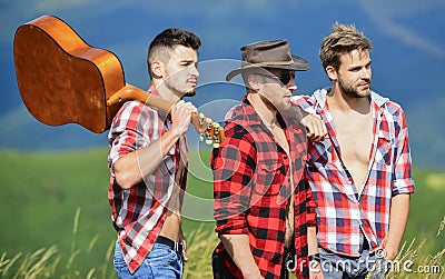 Music is poetry. men with guitar in checkered shirt. western camping. campfire songs. happy men friends with guitar Stock Photo