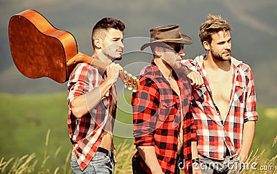 Music is poetry. men with guitar in checkered shirt. western camping. campfire songs. happy men friends with guitar Stock Photo