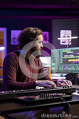 Music producer adding tunes as sound effects for a new soundtrack Stock Photo
