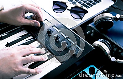 Music producer is producing on synthesizer keyboard Stock Photo