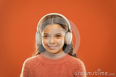 Music produces pleasure. Perfect sound stereo headphones. Girl cute little child wear headphones listen music. Kid Stock Photo