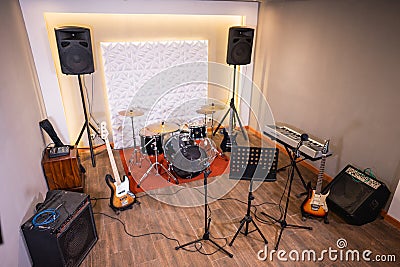 music room with drum set and guitar, bass and sound system Stock Photo