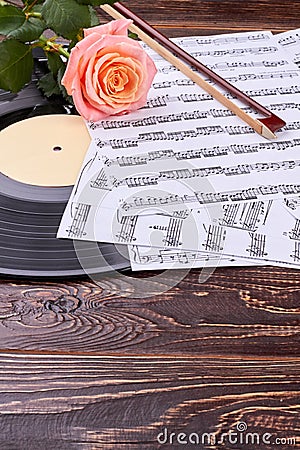 Music sheets, lp record, bow and rose. Stock Photo