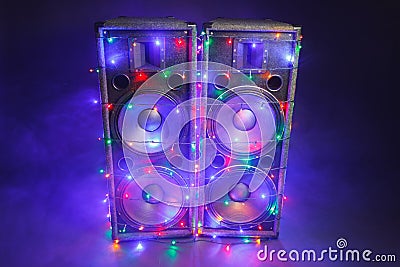 Music speakers with festive Christmas lights and smoke Stock Photo