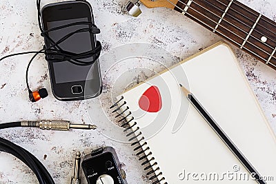 Music stuff. Guitar, guitar pedal, headphone, mobile phone on white background. Top view. Flat lay Stock Photo