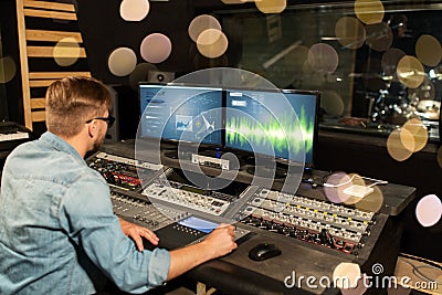 Man at mixing console in music recording studio Stock Photo