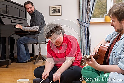 Music therapy with a mentally disabled woman Stock Photo