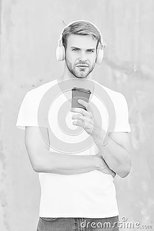 On music vibes. Modern guy drink coffee listening to music. Modern technology for youth. Takeaway drink. Modern music Stock Photo