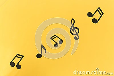 Musical background. notes on a yellow background. Stock Photo