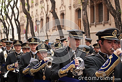 The musical band precedes the procession of the holy week,Seville,16-004-2017 Editorial Stock Photo