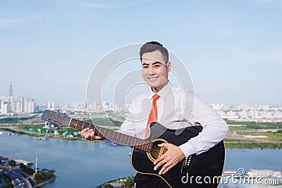 Musical Concept. Casual man playing practicing guitar. Stock Photo