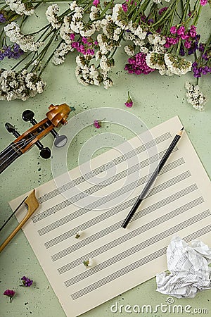 Musical creativity concept. Fictional sheet music, flowers and v Stock Photo