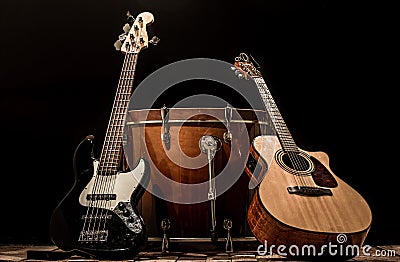 musical instruments, bass drum barrel acoustic guitar and bass guitar on a black background Stock Photo