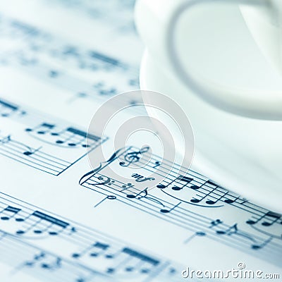 Musical notation and a white coffee cup Stock Photo