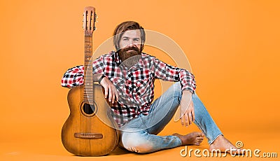 musical school. country music style. man wearing checkered shirt and hold guitar. play string musical instrument Stock Photo