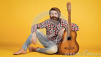 musical school. country music style. man wearing checkered shirt and hold guitar. play string musical instrument Stock Photo