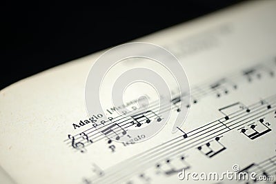 Musical tempo `Adagio` in an old music notebook Stock Photo