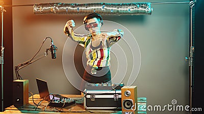 Musician artist using stereo turntables for techno dance party Stock Photo