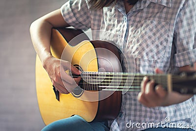 Musician girl playing acoustic guitar Stock Photo