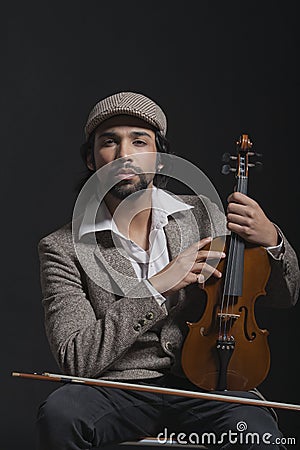 Musician holding a violin Stock Photo