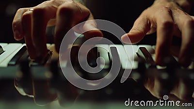 Musician making music in dark hall Man hands pressing keys on piano indoor. Stock Photo