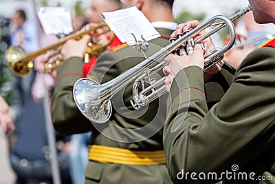 Musician of military orchestra playing trumpet during parade Stock Photo