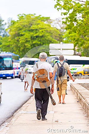 Musician and photographer on the city street, Havana, Cuba. Vertical. Editorial Stock Photo