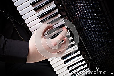 Musician plays the accordion against a dark background Stock Photo