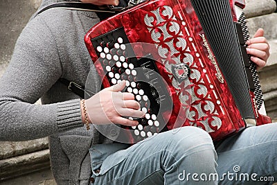 Musician plays the bayan in the street of city Stock Photo