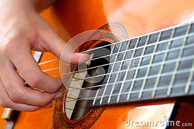 Musician plays guitar fingers Stock Photo