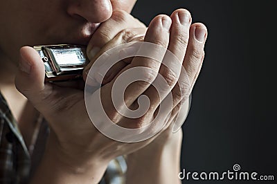 Musician plays the harmonica Stock Photo