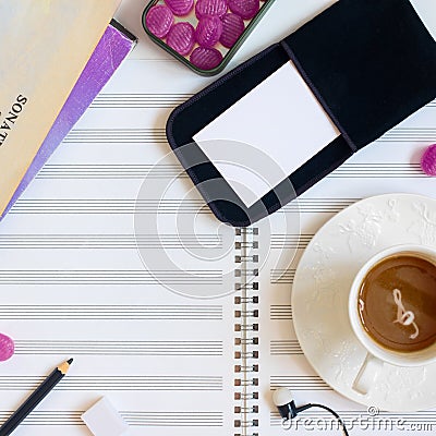 Musician`s desk with music sheets, cup of coffee and mess Stock Photo