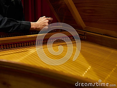 Musician tunes historical harpsichord cembalo with his hands before the concert. Stock Photo