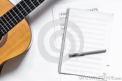 Musician work set with blank paper for notes and guitar white table background top view space for text Stock Photo