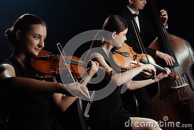Of musicians playing on double bass Stock Photo