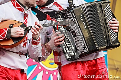 Musicians in traditional Russian clothes on fair Editorial Stock Photo